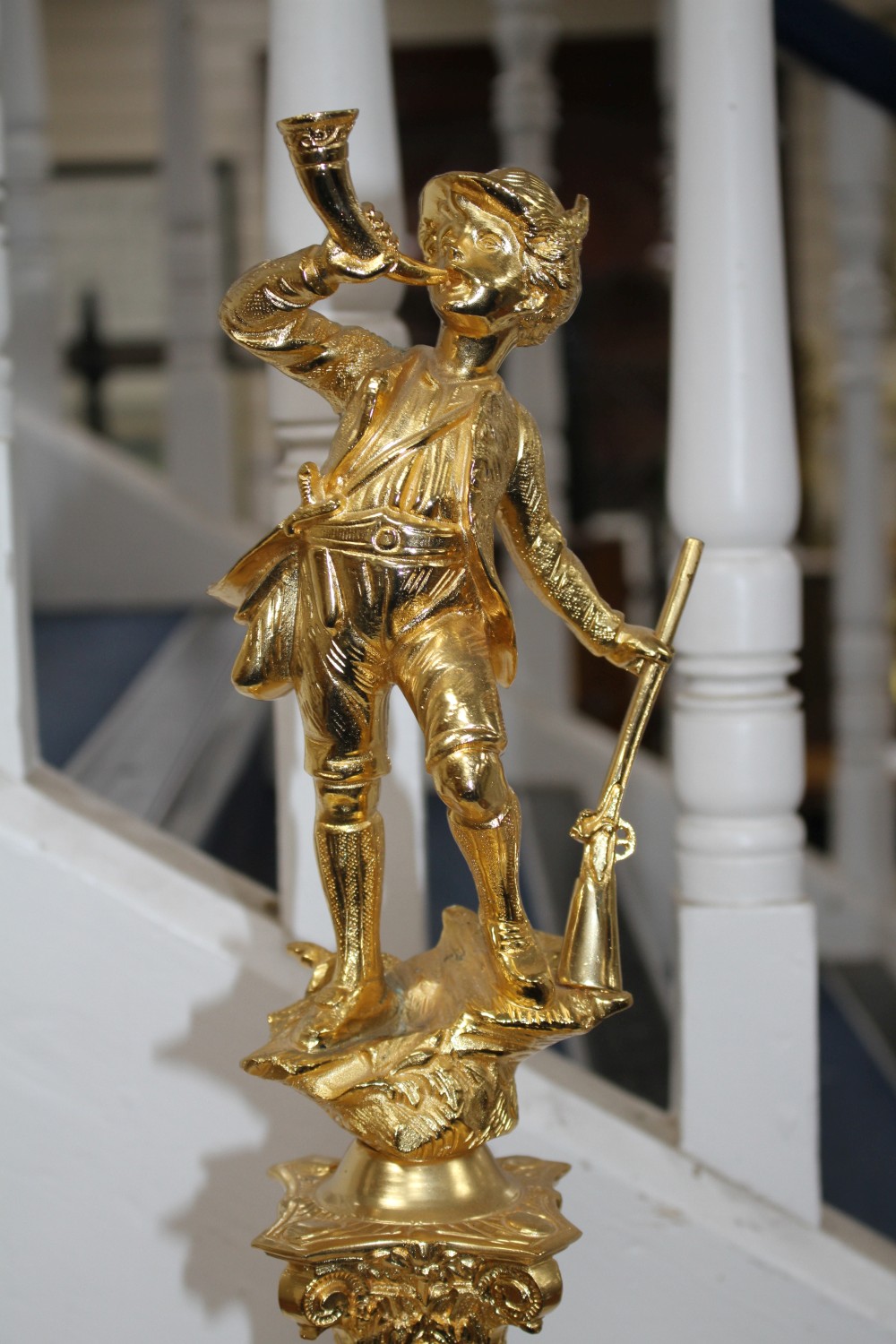 An ornate Italian gilt metal and marble centrepiece, modelled with a huntsman blowing his horn, height 72cm
